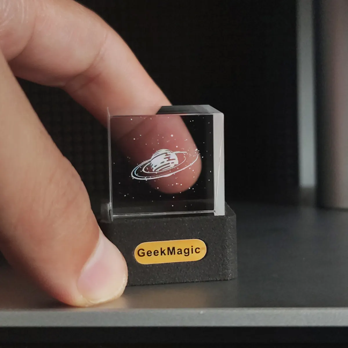 HelloCubic Lite held next to a finger